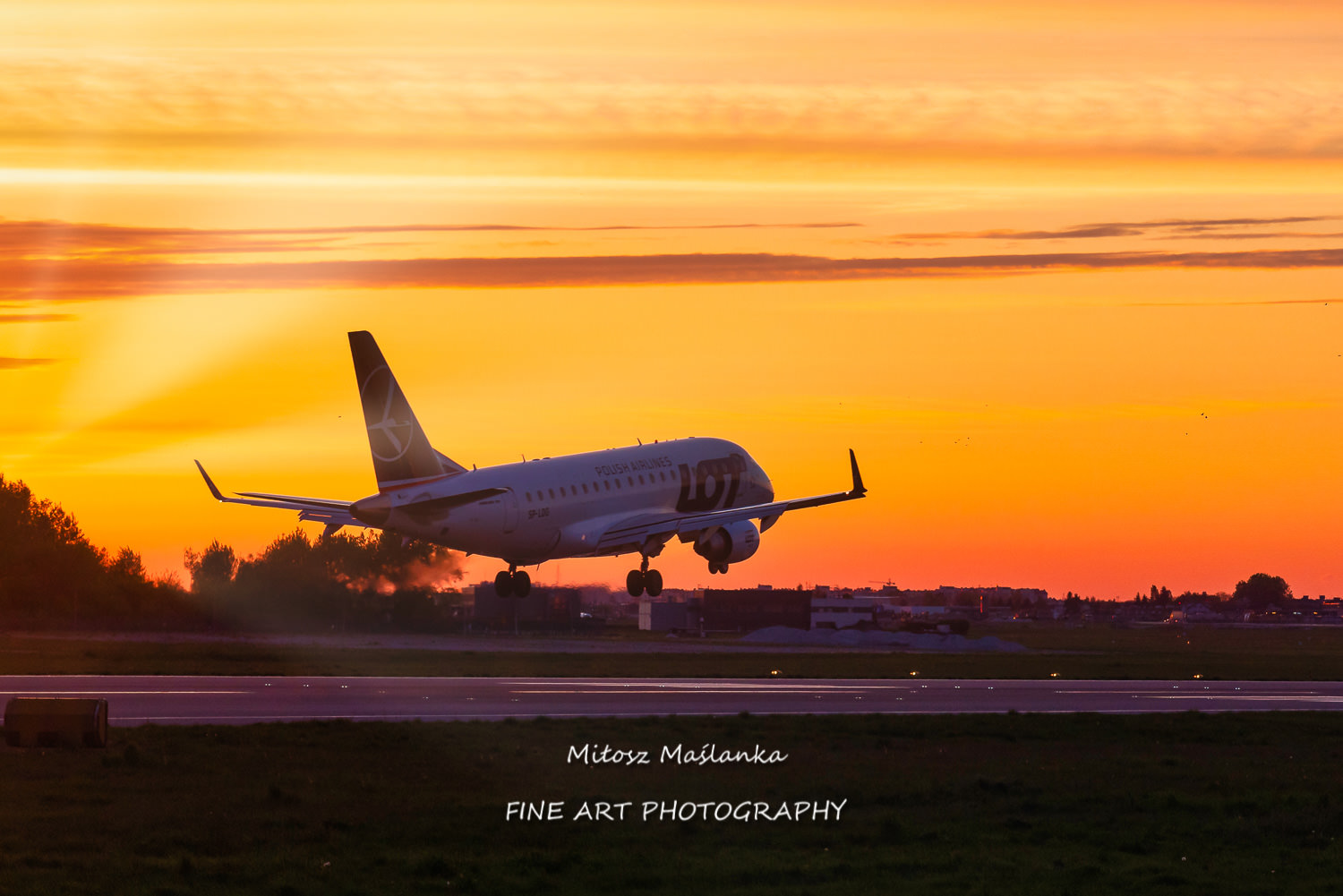 LOT Polish Airlines airplane touching down at Chopin International Airport in Warsaw, Poland