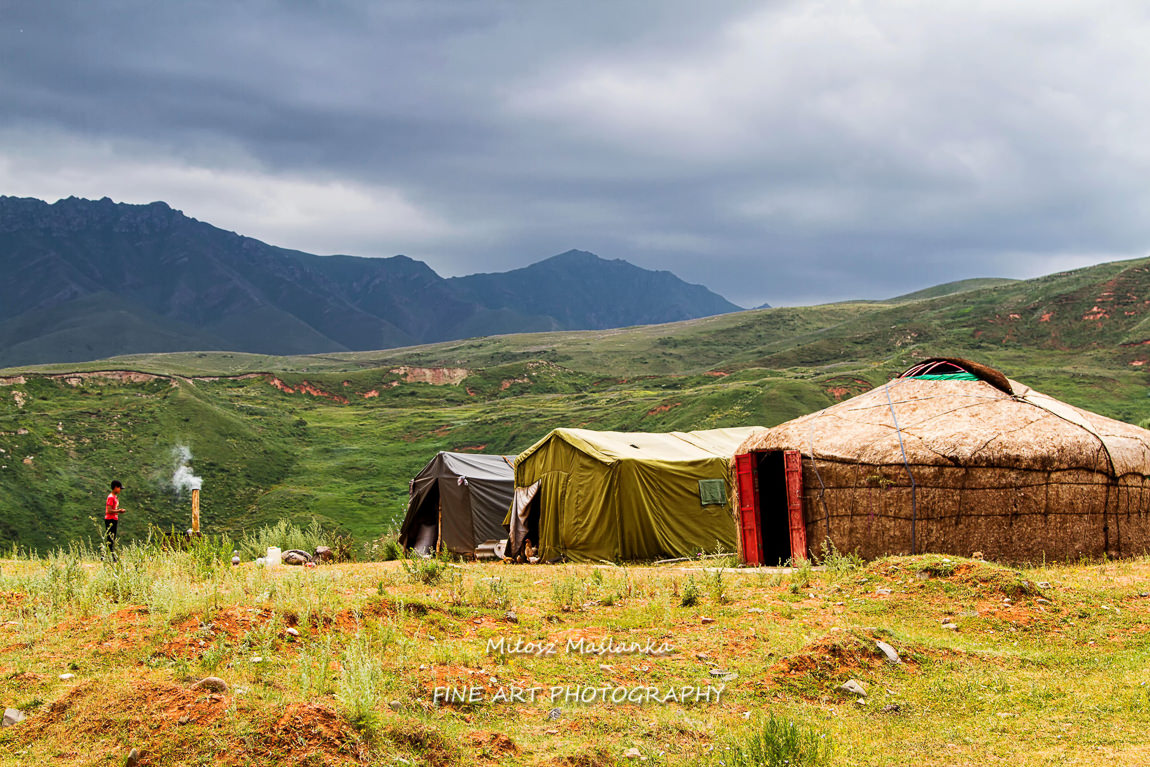 Yurts and tents in Tian Shan mountains near Pamir Highway in Kyrgyzstan, Central Asia