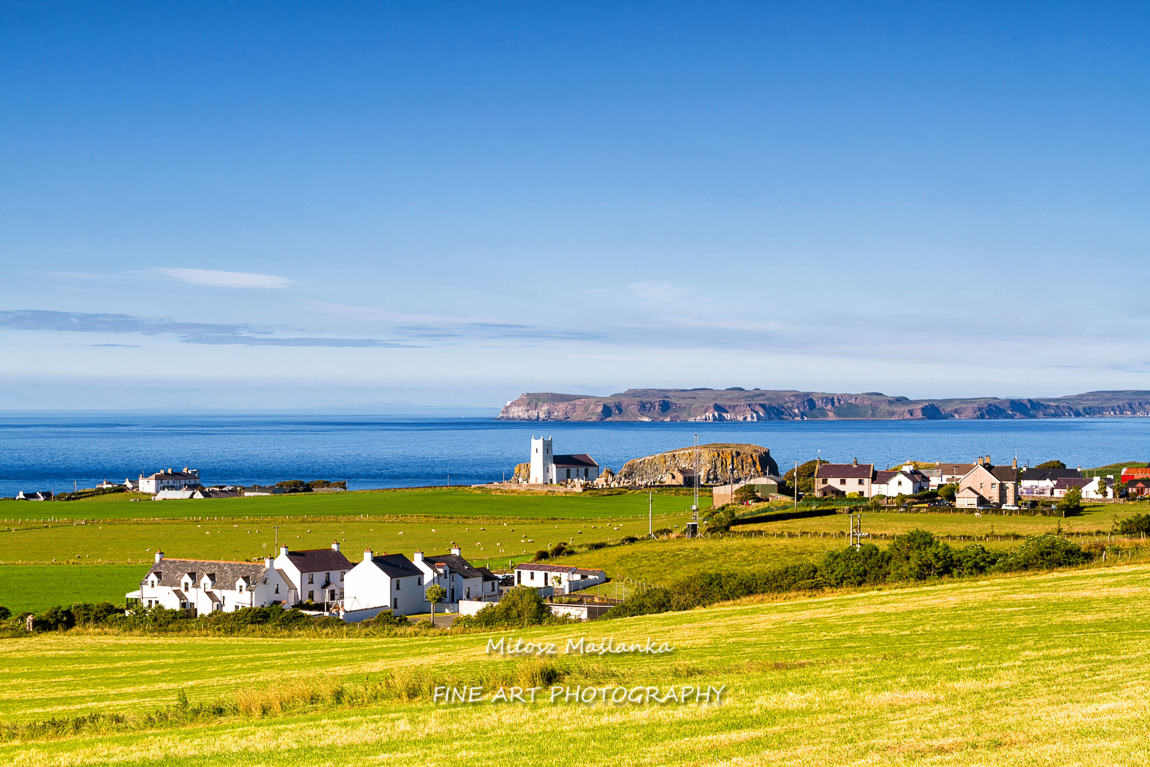 Panorama of an idyllic, peaceful and calm Irish landscape. View of town and village on the rolling hills during warm summer days.