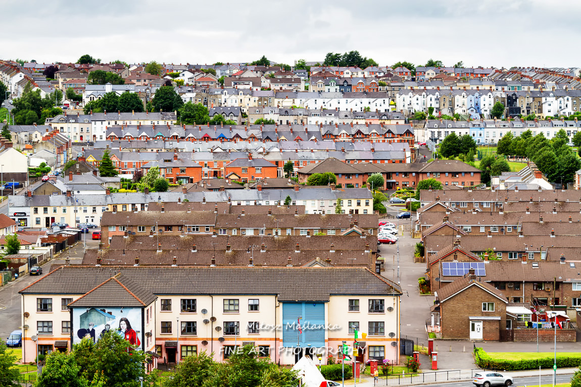 Aerial view of Derry Londonderry city center in Northern Ireland, UK. Sunny day with cloudy sky, city walls and historical buildings