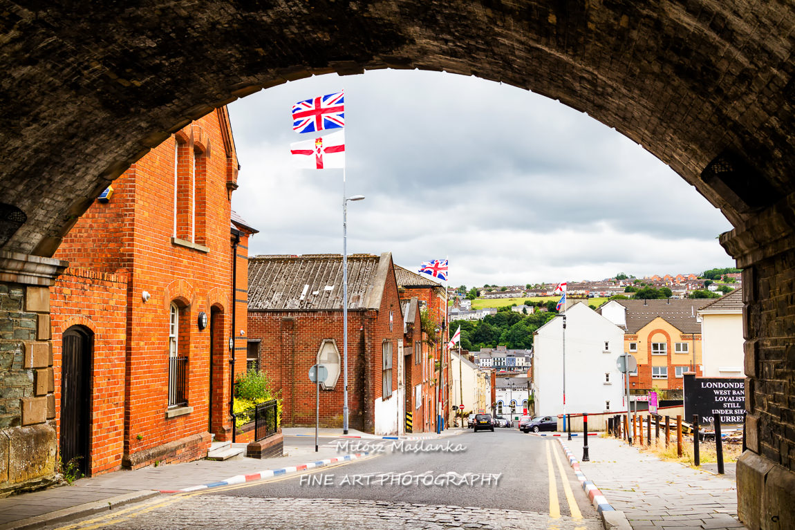 Aerial view of Derry Londonderry city center in Northern Ireland, UK. Sunny day with cloudy sky, city walls and historical buildings