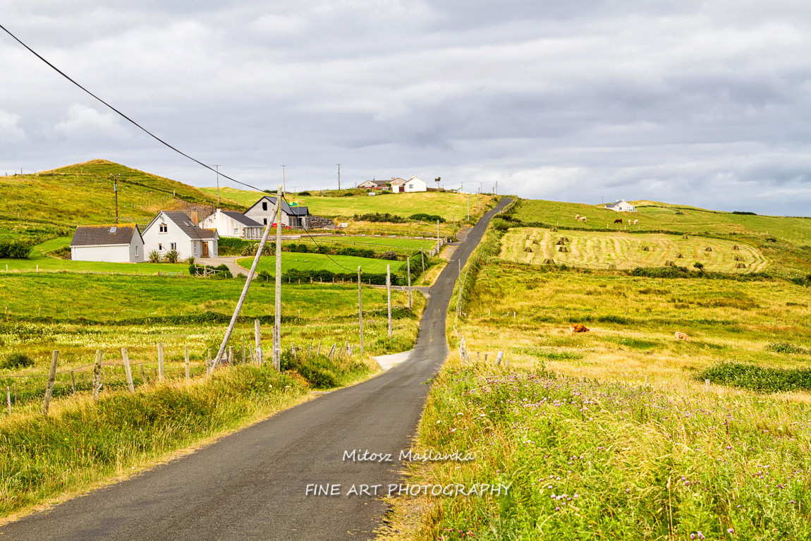 Summer landscape of pastures, hills and meadows in popular and picturesque Irish coast near Donegal