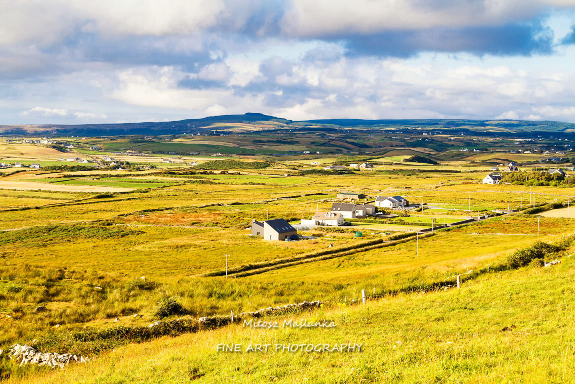Summer landscape of pastures, hills and meadows in popular and picturesque Doolin, Ireland near Cliffs of Moher