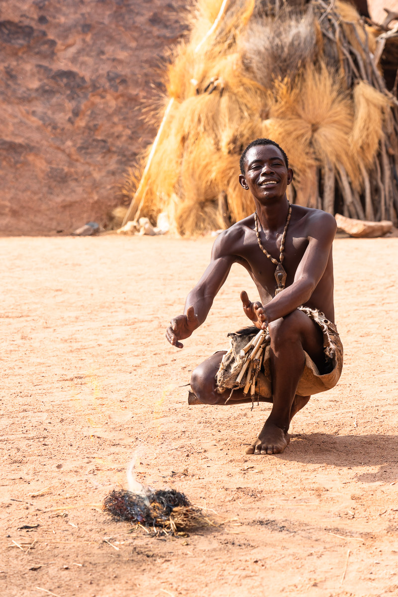 Man from Damara tribe starting a fire using traditional methods
